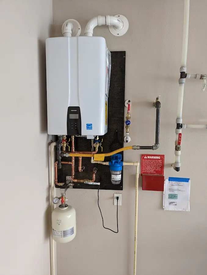 Professional plumber installing copper piping in a Ahtanum home